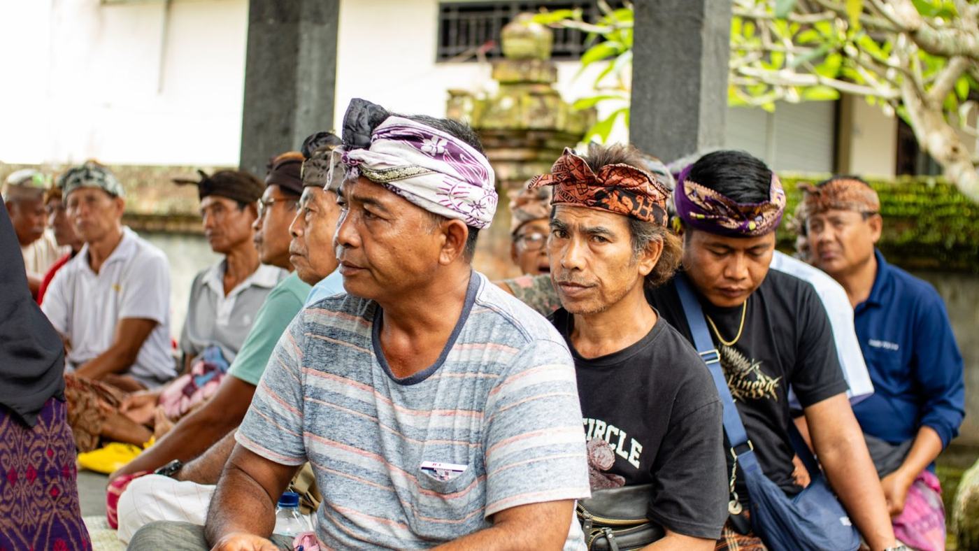 Balinese farmers in traditional headcloths gathered for a training session